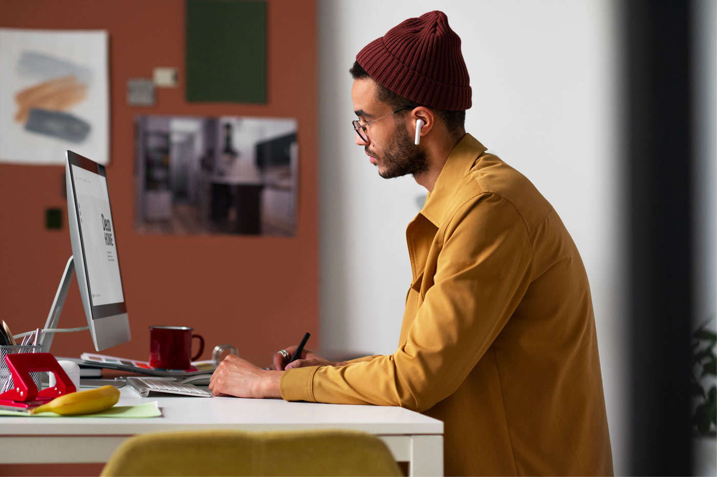 Professional presentation designer working at a desktop computer in a modern home office